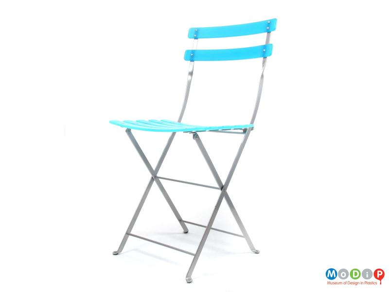 Front side view of an Habitat folding chair showing the two back slats and the metal frame.