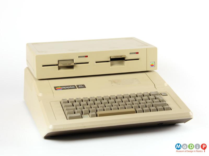 Front view of an Apple IIe showing the disk drive and computer stacked together.
