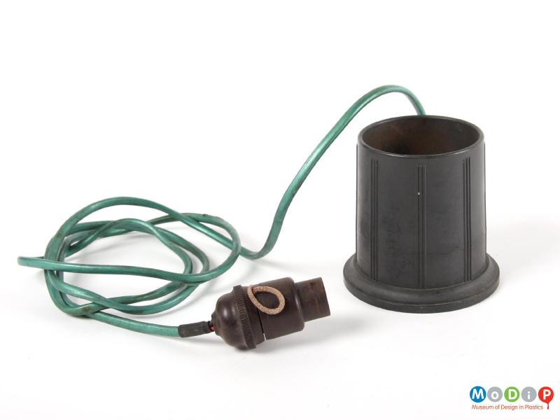 Side view of a bottle warmer showing the light fitting plug.