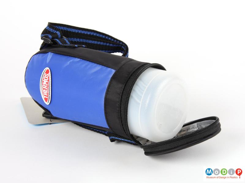 Side view of a Thermos insulated bottle showing the base unzipped to reveal the bottle inside.
