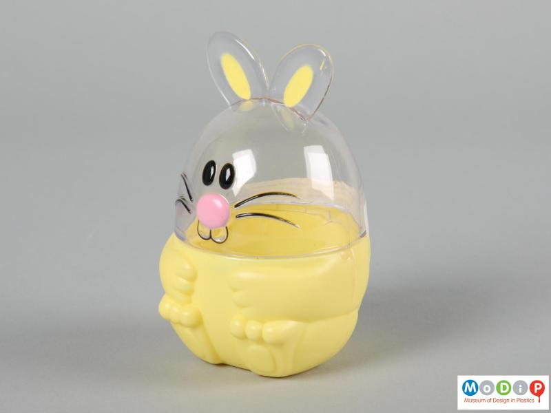 Side view of a Funny Bunny sweet container showing the moulded feet shapes in the base and face in the top section.