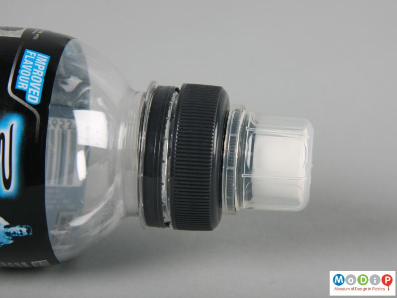 Side view of a Powerade bottle showing the dust cap in place.