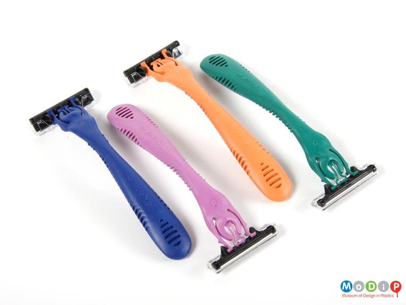 Top view of a pack of disposable razors showing the top surface of the four razors.