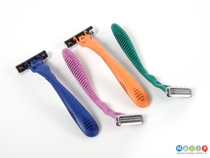 Underside view of a pack of disposable razors showing the underneath of two of the razors.