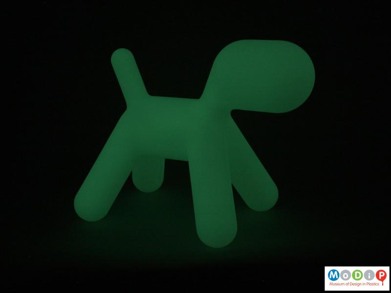 Side view of a stool showing it glowing in the dark.