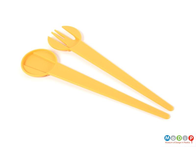 Top view of a set of salad servers showing the straight handles.
