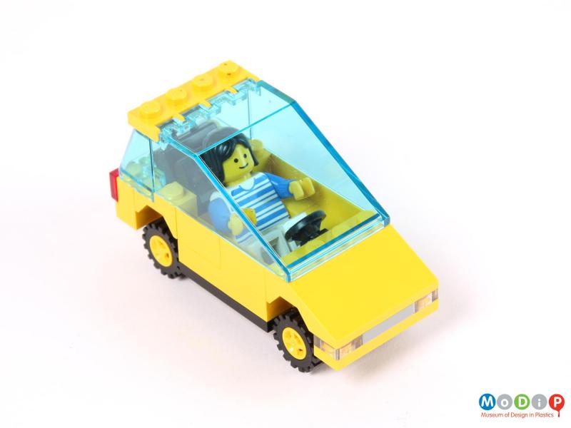 Top view of a toy car showing the figure in the driver's seat.