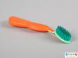Side view of a toothbrush showing the large handle and brush head.