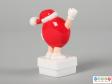 Side view of a red M&M figure showing the plain back.