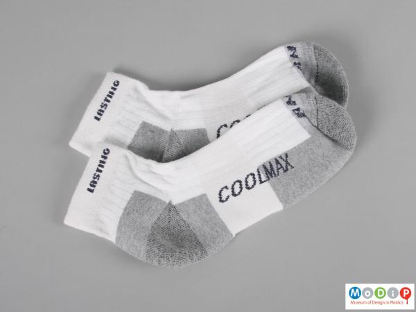 Side view of a pair of socks showing the ankle length.