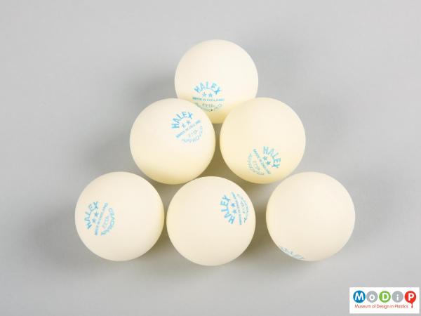Side view of a set of table tennis balls showing the printed information on the balls.