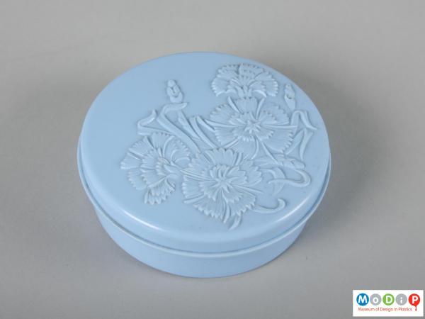 Top view of a powder pot showing the moulded cornflower decoration in the lid.