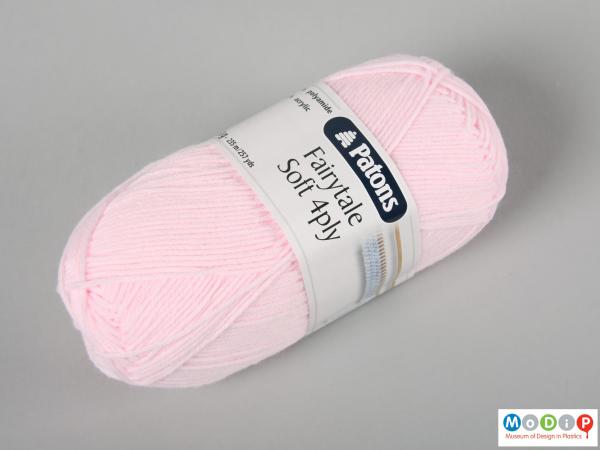 Side view of a ball of yarn showing the label.