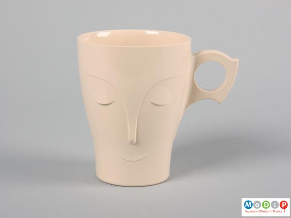Front view of a mug showing the stylised face.