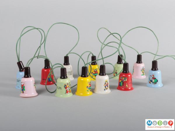 Side view of a set of fairy lights showing the different coloured bell shaped covers.