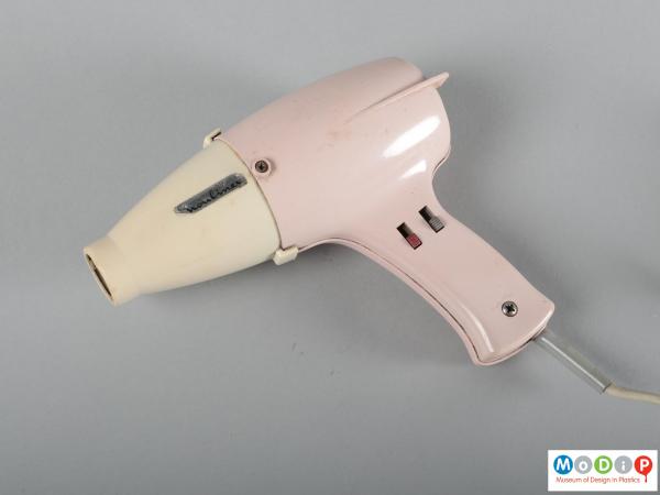 Side view of a hairdryer showing the control knobs.