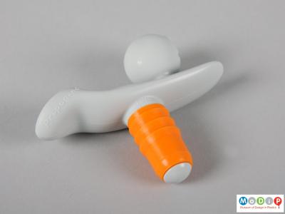 Side view of a bottle stopper showing the orange sheathing.