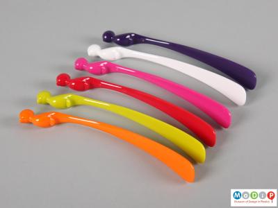 Side view of a set of cocktail stirrers showing the long tails.