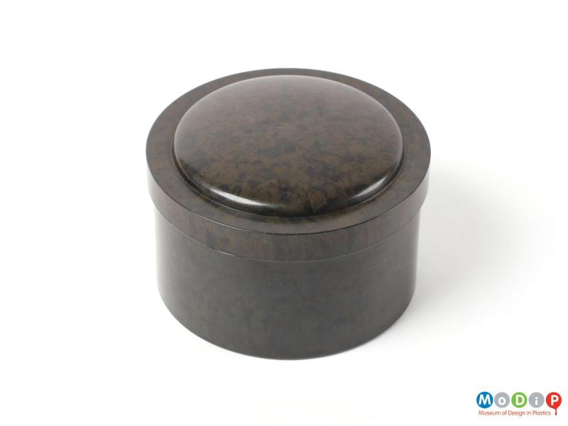 Top view of a round phenol formaldehyde box showing the plain sides and decorative mound on the lid.