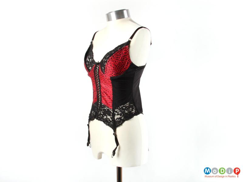 Side view of a cami-suspender showing the lace design.
