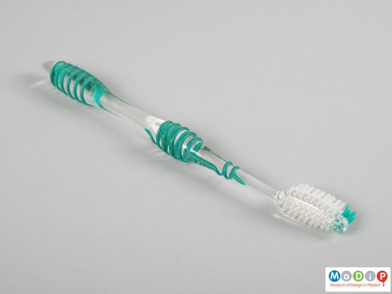 Side view of a toothbrush showing the tapering head.