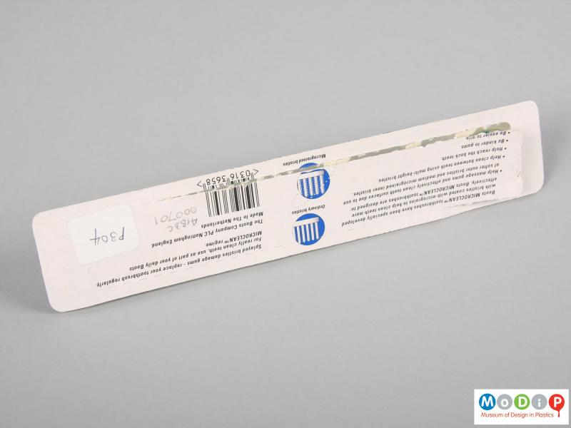 Side view of a toothbrush showing the packaging.