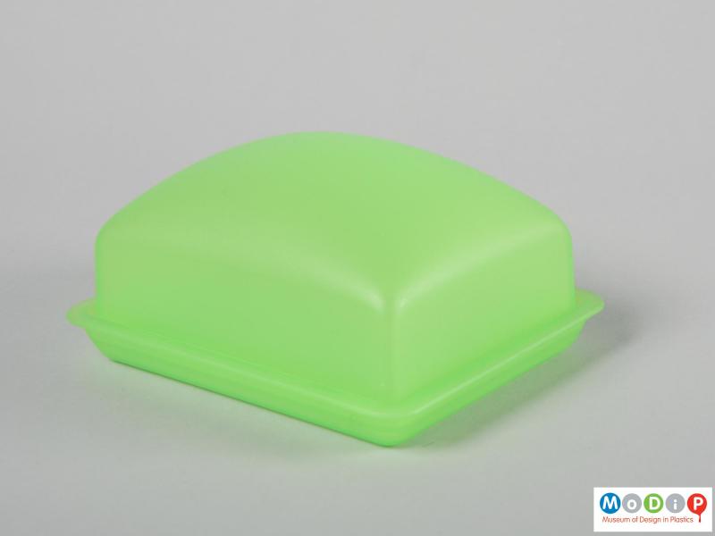 Side view of a butter dish showing the smooth shape.