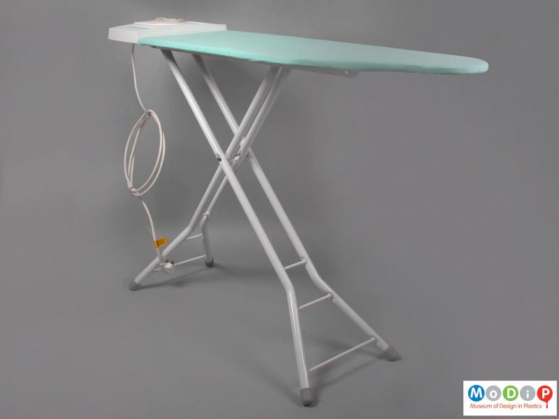 Side view of a Thormogem Ironing System showing the ironing board with the x frame at the base.