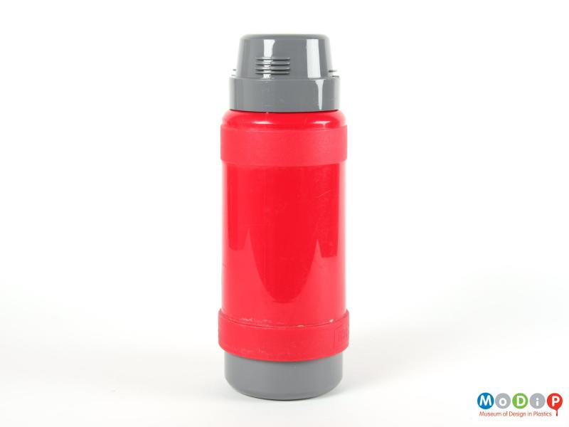 Side view of a Thermos flask showing the red body and grey cup and base.