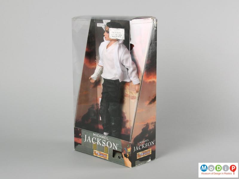 Side view of a Michael Jackson doll showing the doll in its original packaging.