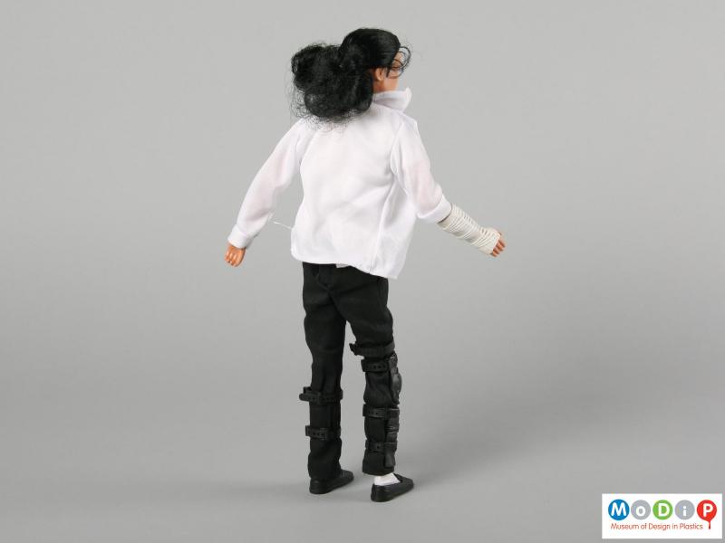 Rear view of a Michael Jackson doll showing the bandaged hand.
