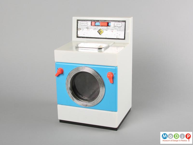Front view of a Casdon toy washing machine showing the closed door of the machine.