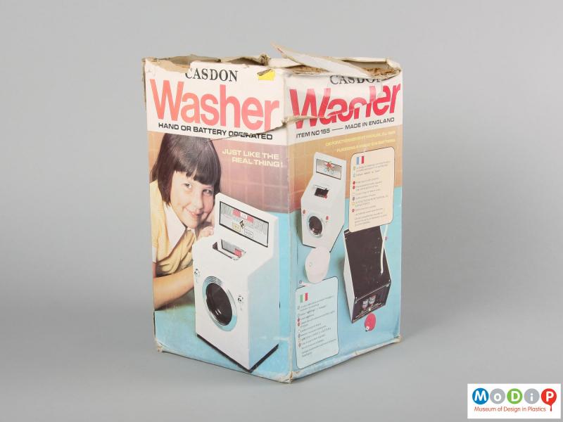 Side view of a Casdon toy washing machine showing the cardboard packaging.