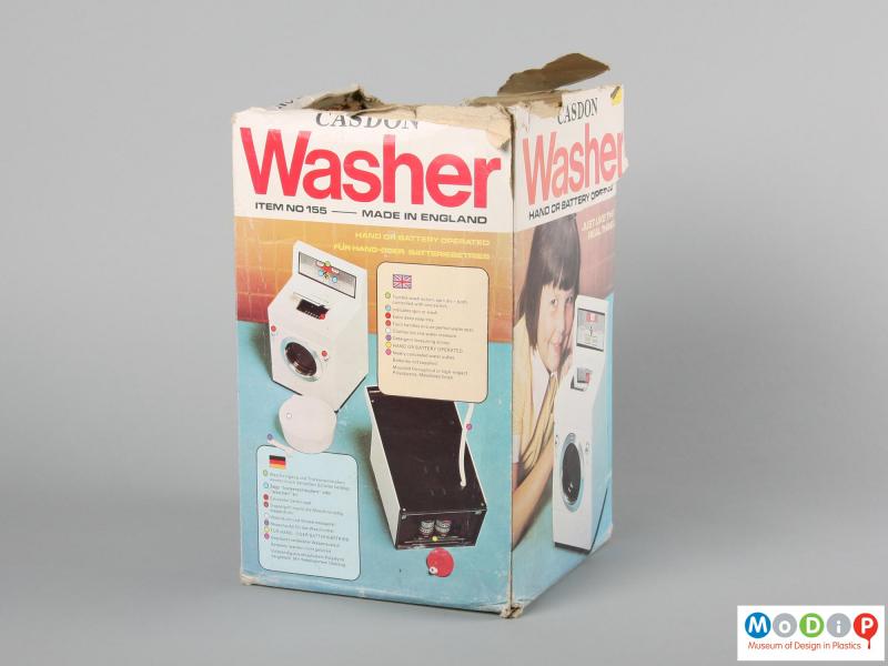 Side view of a Casdon toy washing machine showing the cardboard packaging.