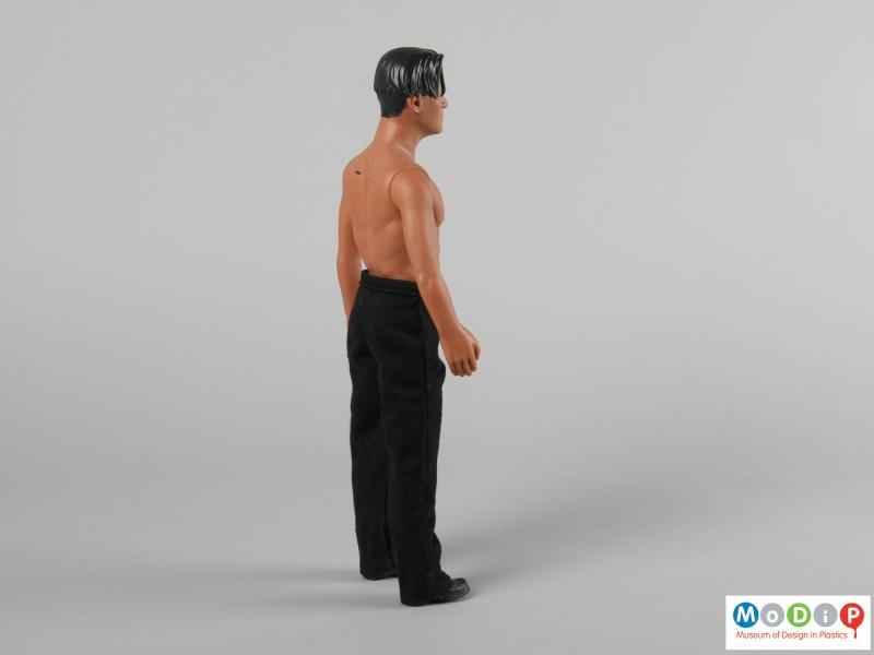 Side view of a Peter Andre doll showing the figure standing.