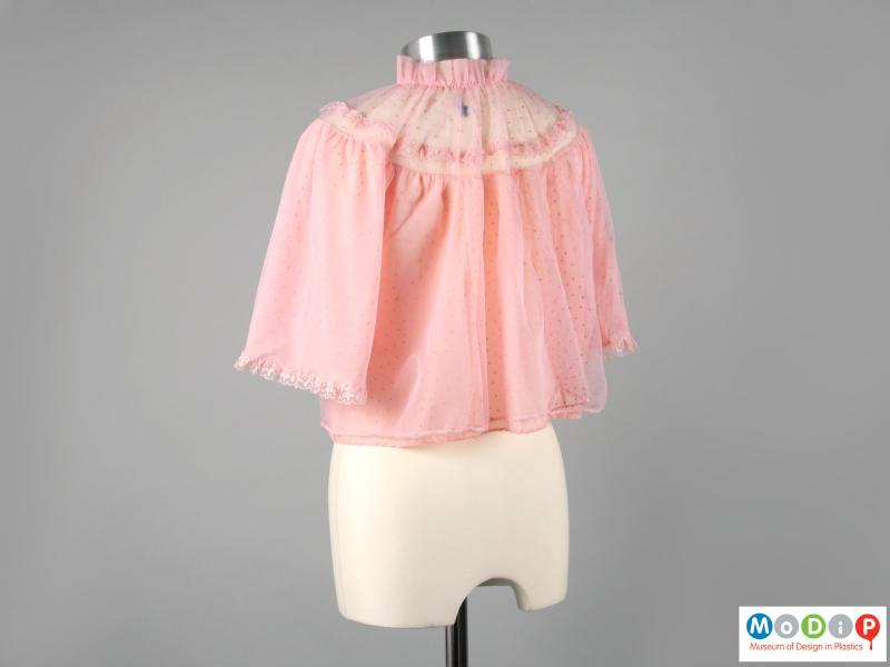 Rear view of a bed jacket showing the high collar.