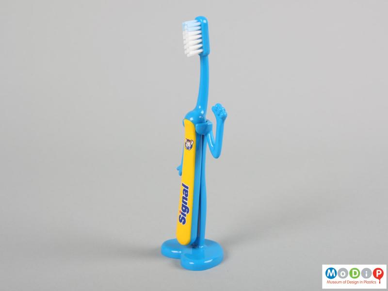 Side view of a Signal toothbrush showing the brush in the holder.