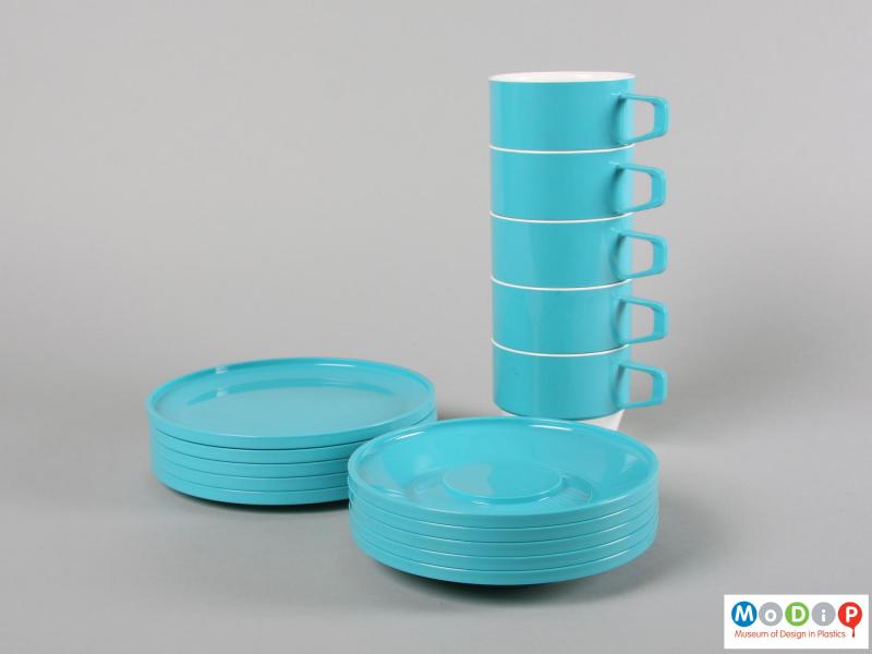 Side view of a set of tableware showing the cups, saucers and plates.