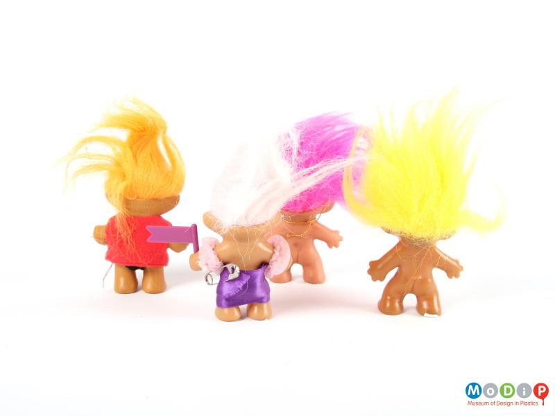 Rear view of 4 Trolls showing their long hair.