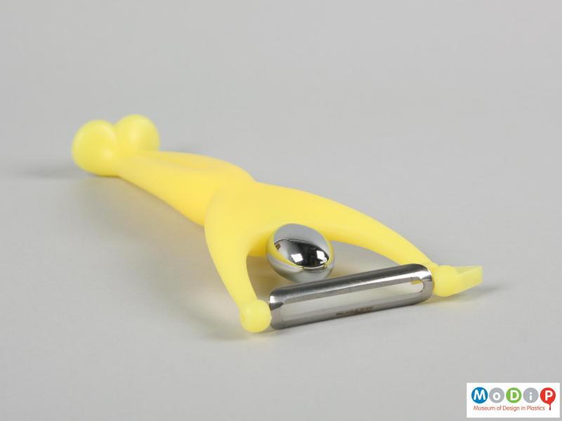 Top view of a vegetable peeler showing the blade and chromed head.