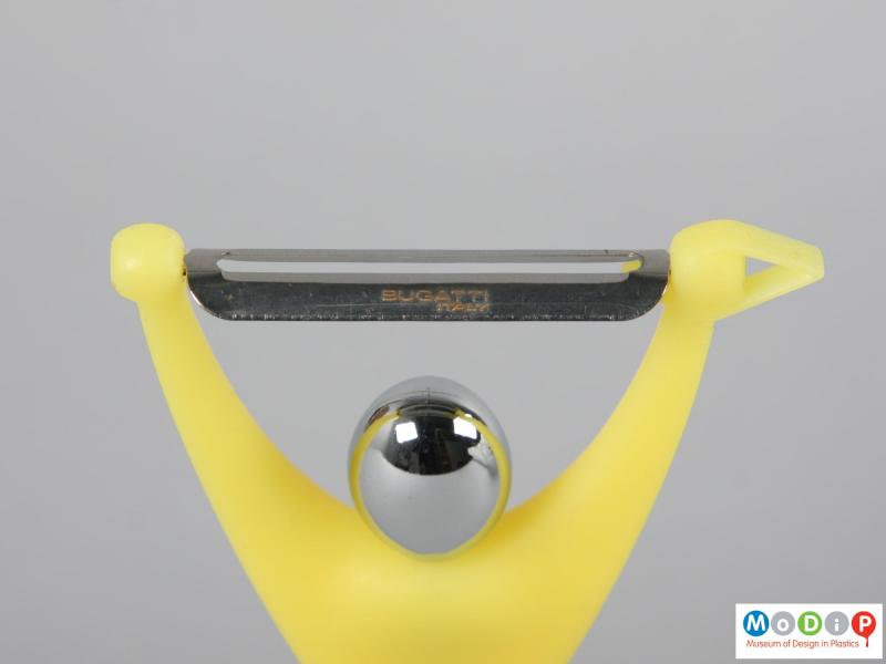 Close view of a vegetable peeler showing the blade and chromed head.