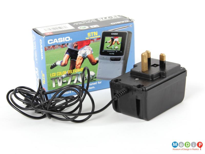 Front view of a Casio portable TV showing the transformer & cable and the card packaging.