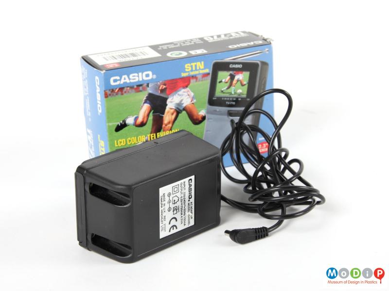 Front view of a Casio portable TV showing the transformer & cable and the card packaging.