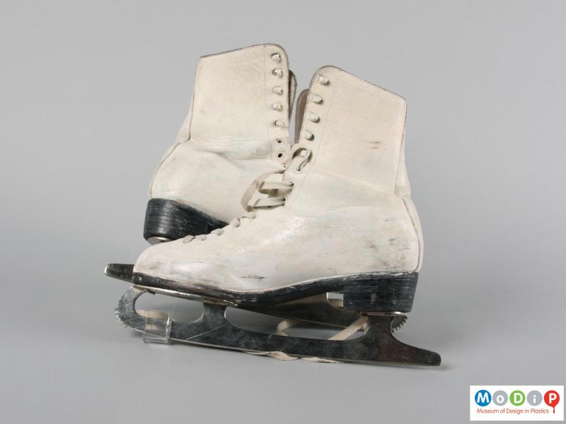 Side view of a pair of ice skates showing the blades.