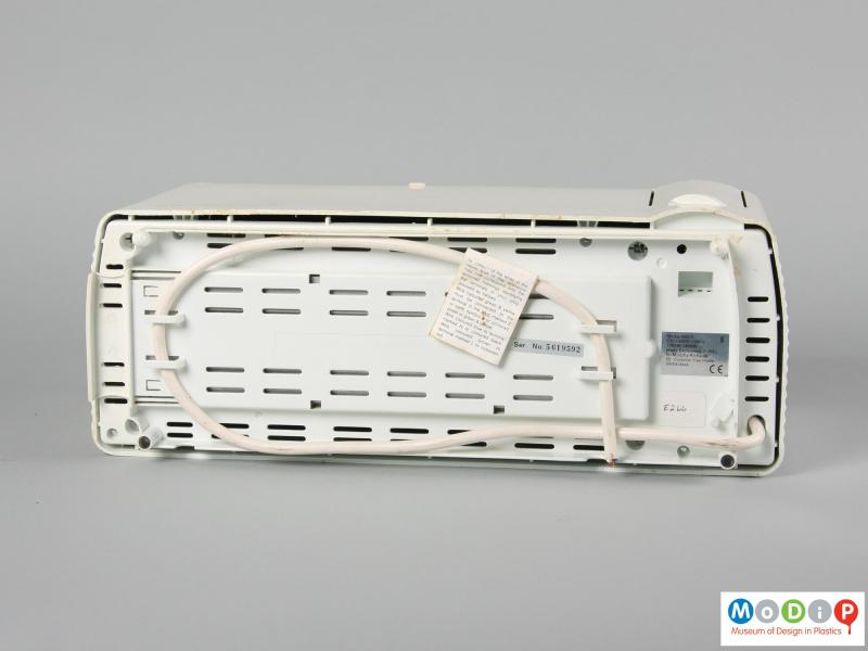 Underside view of a Morphy Richards toaster showing the cable coiled around specific pegs.
