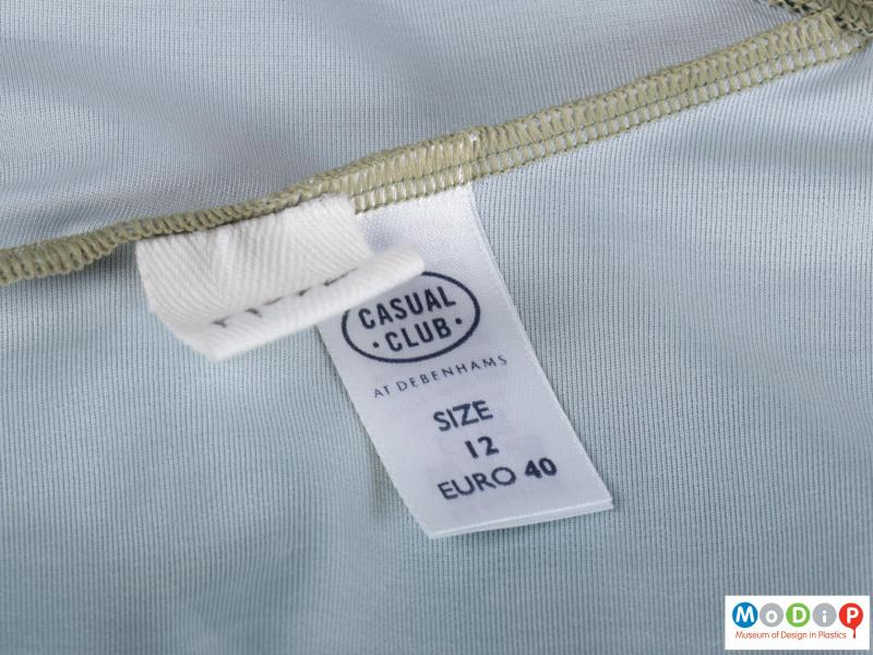 Close view of a swimming suit showing the label.