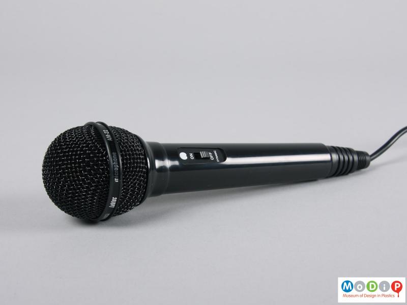 Side view of a microphone showing the grid covered head.