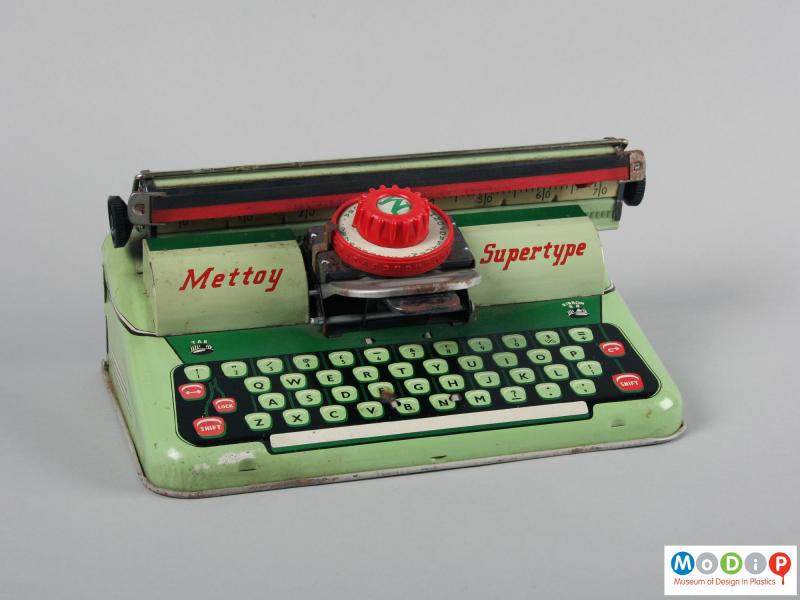 Front view of a toy typewriter showing the carriage movement.