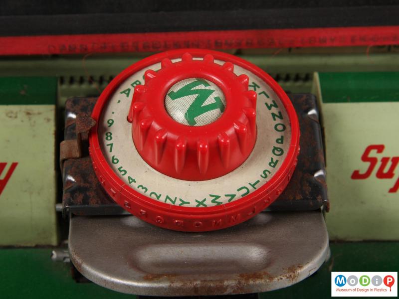Close view of a toy typewriter showing the letter selector.