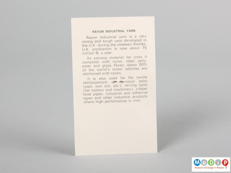 Rear view of a fabric sample card showing the printed information about the material.